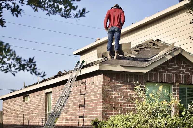 Professional roofer working on a residential roof in Fairpark